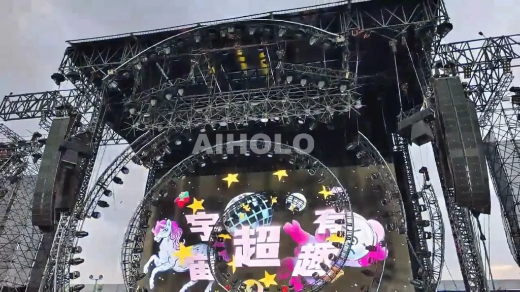 Idol performing in front of 24-unit holographic fan wall displaying 3D fireworks