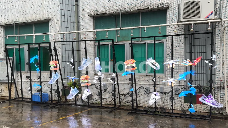 IPX6 waterproof holographic fan operating in heavy rain without protective case showing clear 3D display